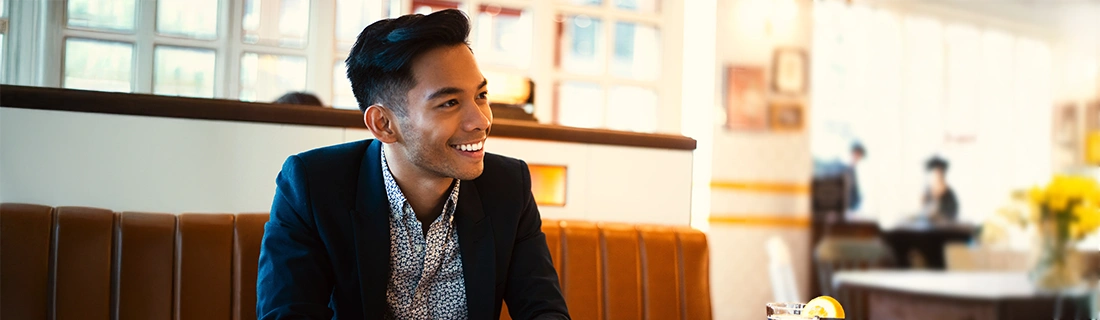 Dentist Parma Heights OH Man Smiling In Restaurant Booth Dentist Parma Heights OH Man Smiling In Restaurant Booth